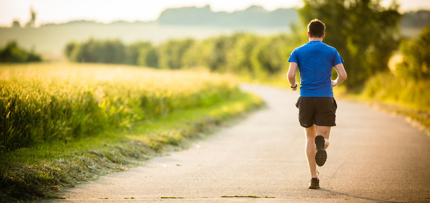 man running through fields
