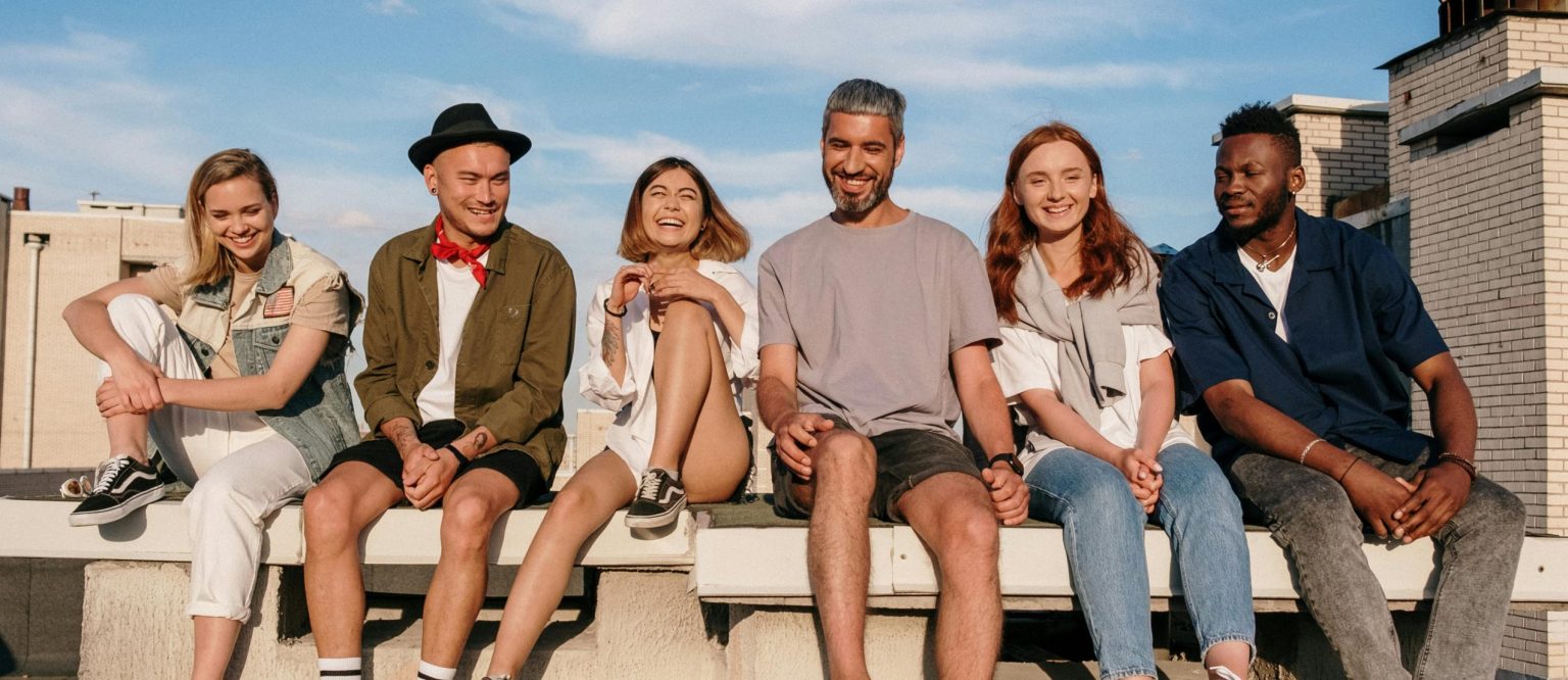 Group of People Sitting on Concrete Bench